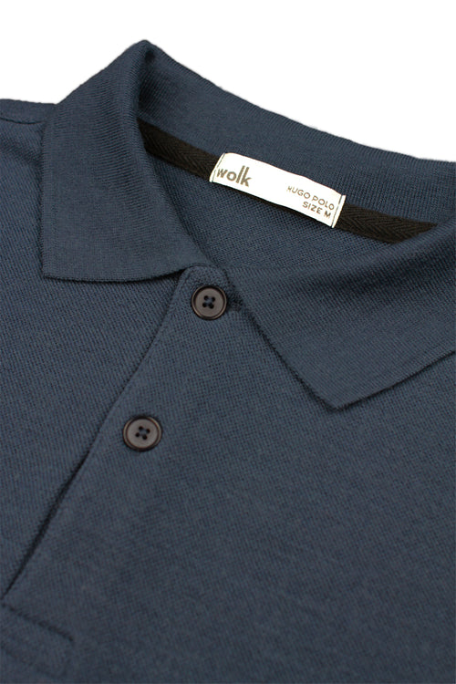 detail of rib collar and corozo buttons on merino wool polo from Wolk